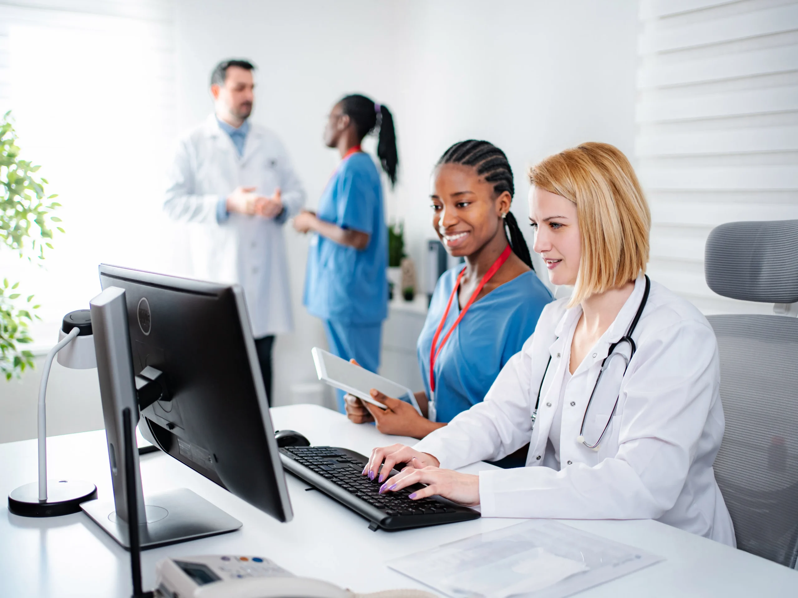 Doctor at a desk using NaviNet on a computer
