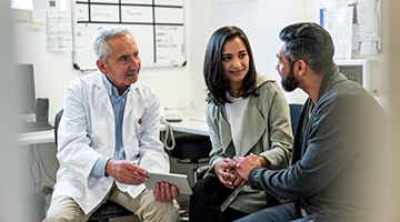 Doctor talking to couple