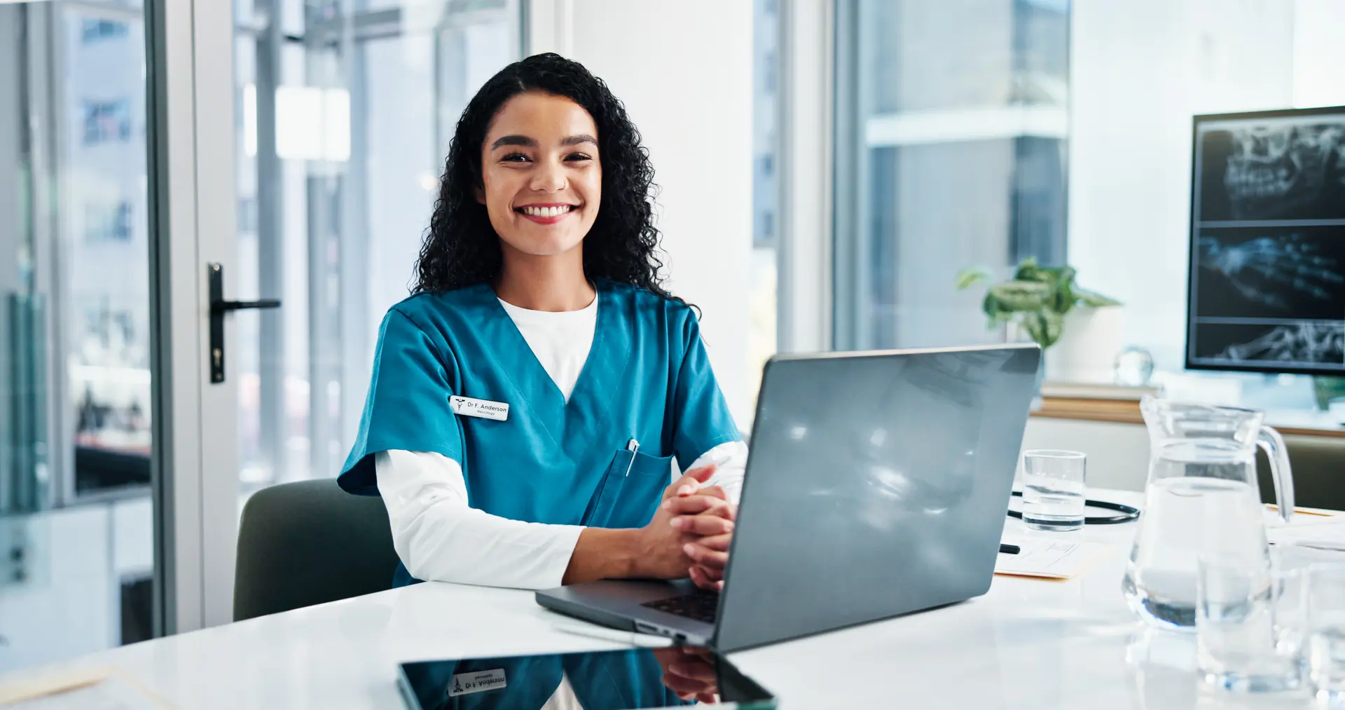 Healthcare professional using NaviNet on a laptop in a clinical office