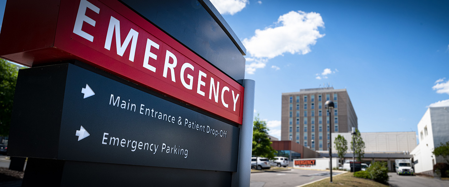 Hospital Emergency Sign with hospital building in the background