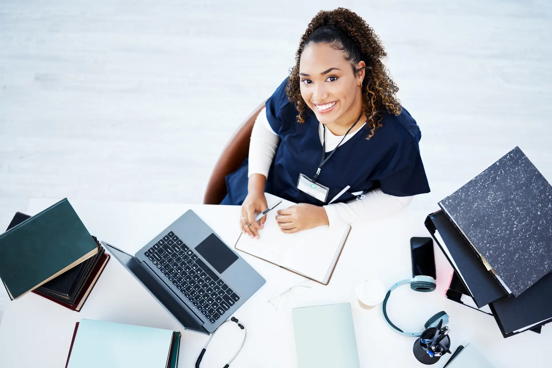 Healthcare professional working on a laptop, top-down view
